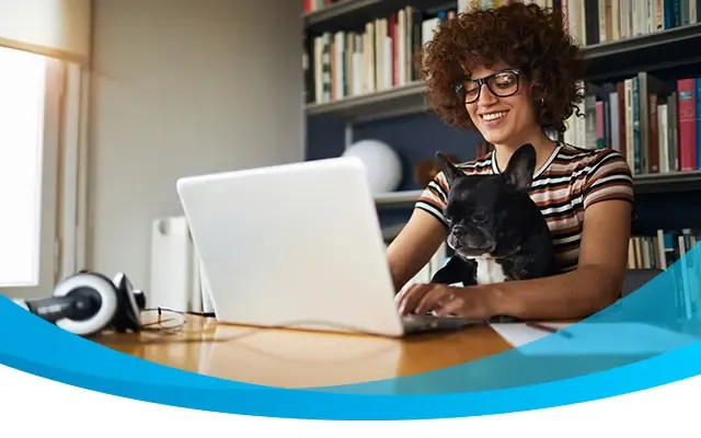 Woman with her dog and computer